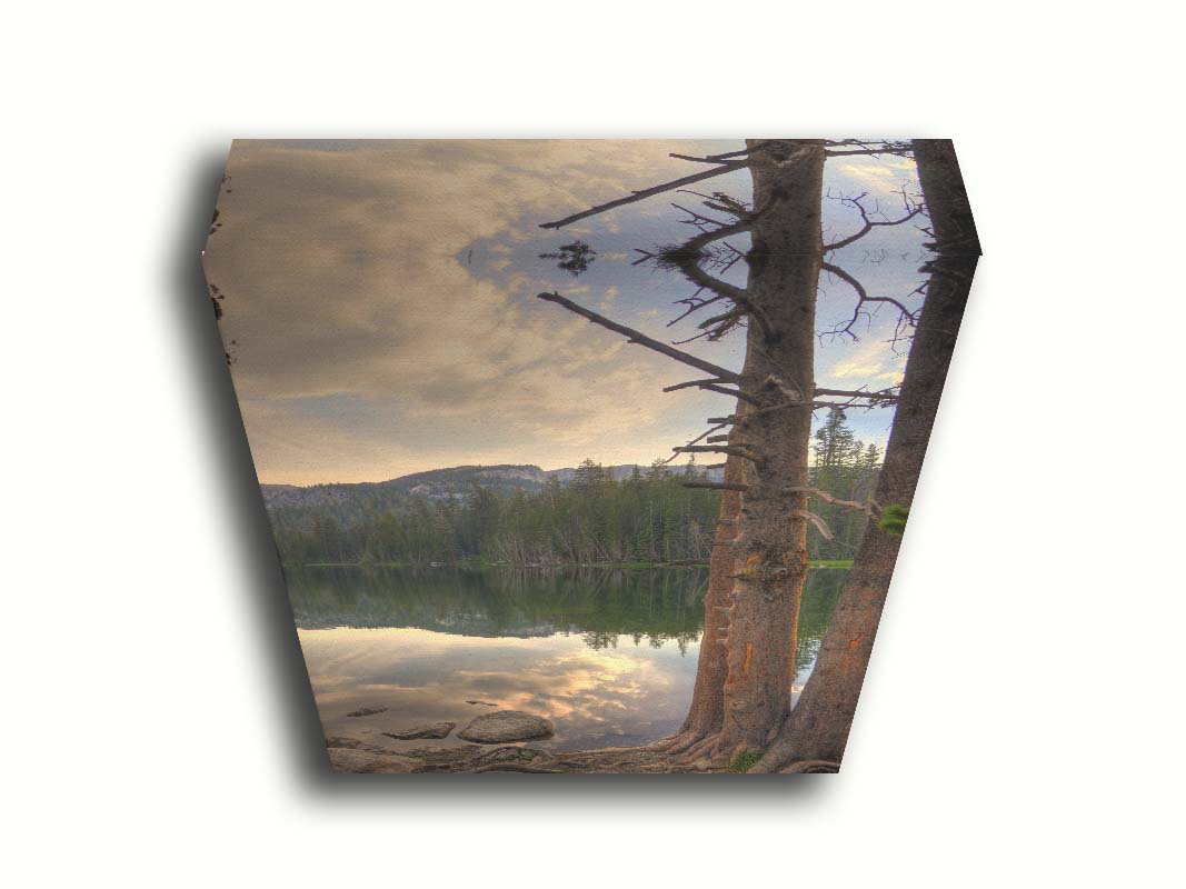 A photo overlooking Lake Mamie at Mammoth Mountain, California. The lake is surrounded by a forest of trees, with the mountains in the background. Printed on canvas.