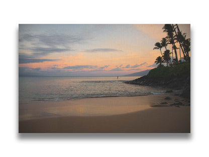 A photo looking out to sea at Maui during sunrise. A surfer can be seen on the water in the distance. Printed on canvas.