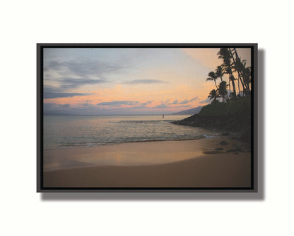 A photo looking out to sea at Maui during sunrise. A surfer can be seen on the water in the distance. Printed on canvas in a float frame.