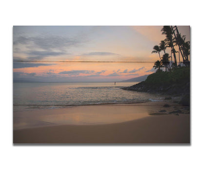 A photo looking out to sea at Maui during sunrise. A surfer can be seen on the water in the distance. Printed on a box board.