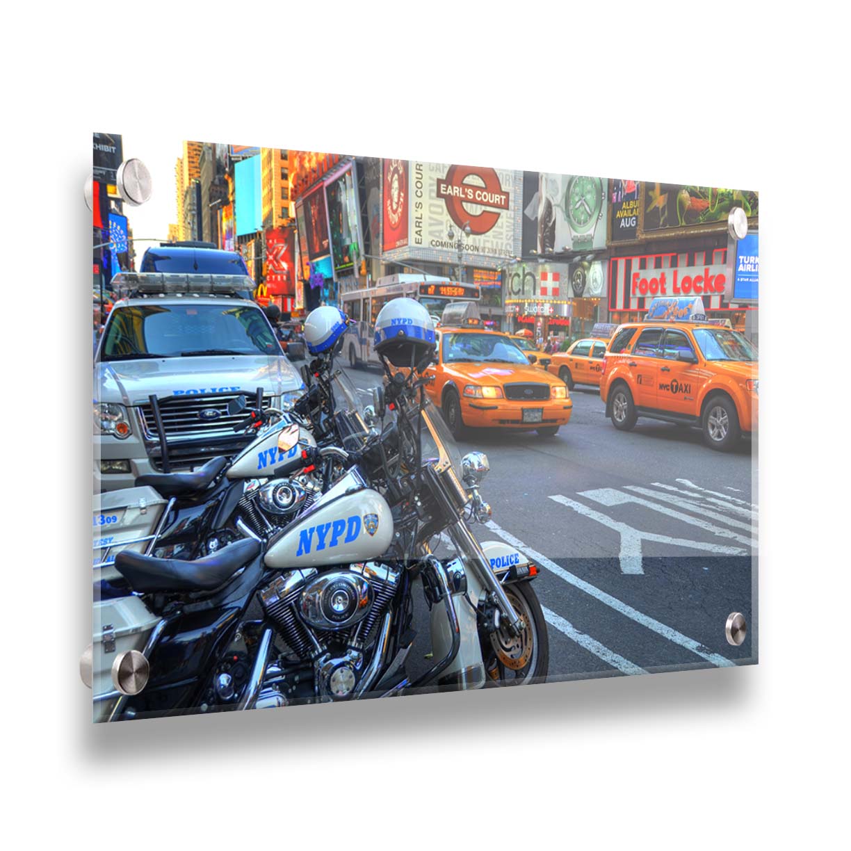 A photo of a street in New York City, featuring several bright orange taxis and New York Police Department vehicles. Printed on acrylic.