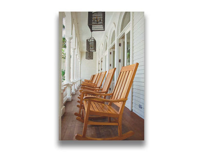 A photo looking down a row of rocking chairs on a porch in O'ahu, Hawaiʻi. Printed on canvas.