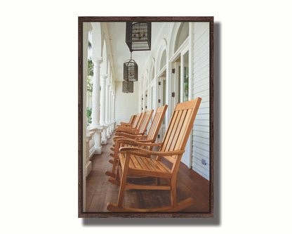 A photo looking down a row of rocking chairs on a porch in O'ahu, Hawaiʻi. Printed on canvas in a float frame.