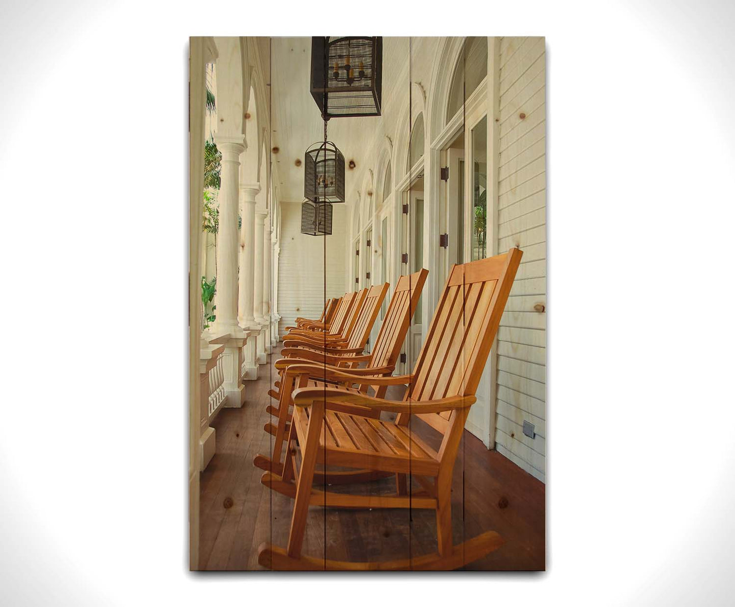 A photo looking down a row of rocking chairs on a porch in O'ahu, Hawaiʻi. Printed on a wood pallet.