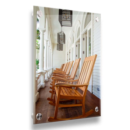 A photo looking down a row of rocking chairs on a porch in O'ahu, Hawaiʻi. Printed on acrylic.