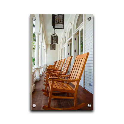 A photo looking down a row of rocking chairs on a porch in O'ahu, Hawaiʻi. Printed on acrylic.