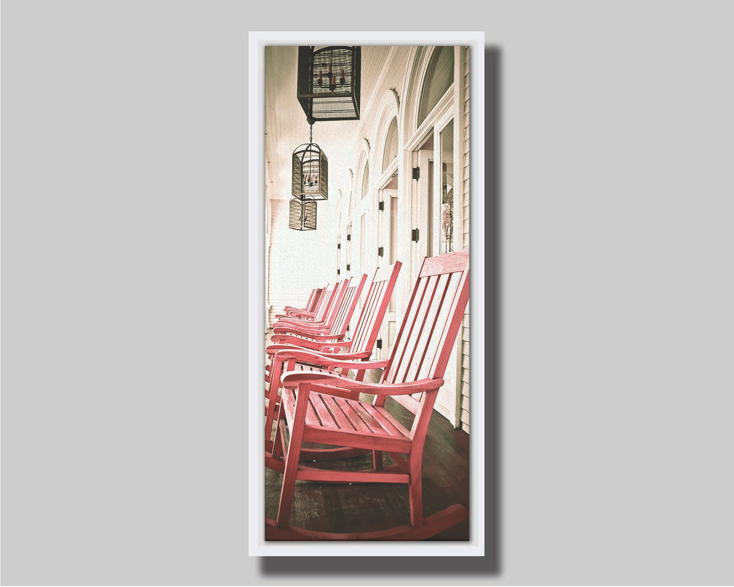 A photo looking down a row of rocking chairs on a porch in O'ahu, Hawaiʻi. Printed on canvas in a float frame.