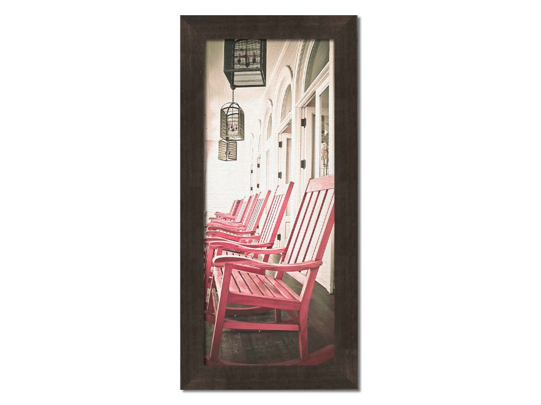 A photo looking down a row of rocking chairs on a porch in O'ahu, Hawaiʻi. Printed on canvas and framed.