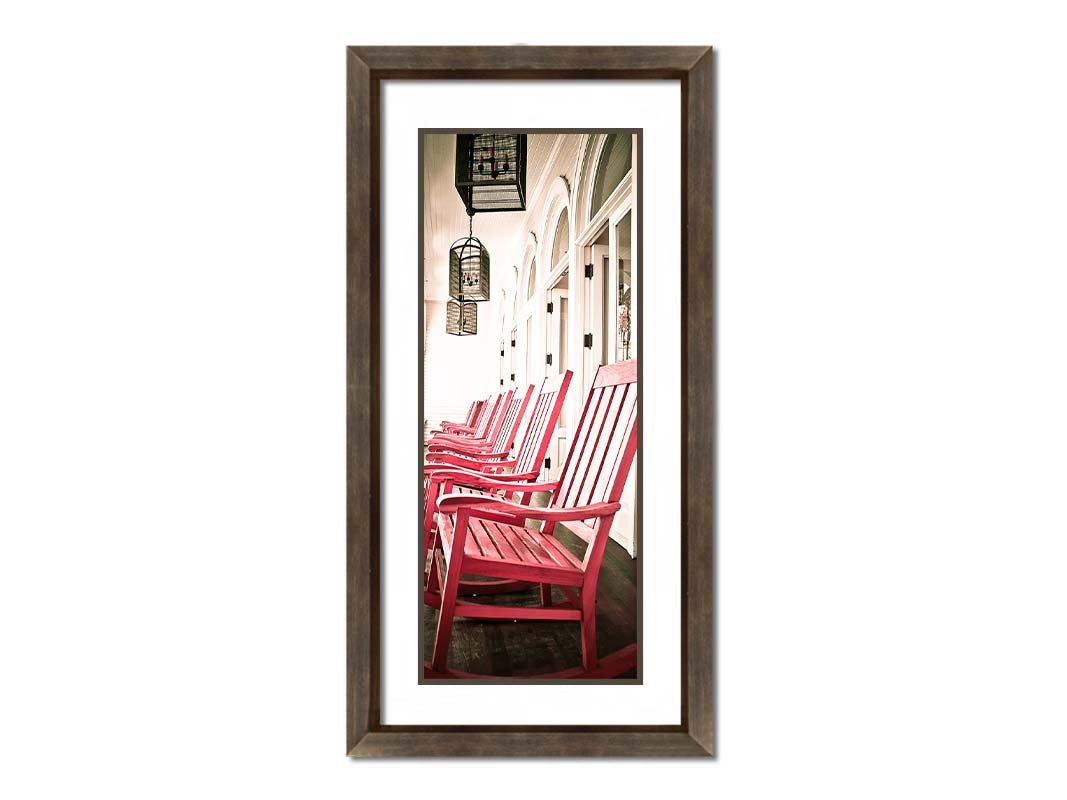 A photo looking down a row of rocking chairs on a porch in O'ahu, Hawaiʻi. Printed on paper, matted, and framed.