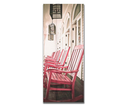 A photo looking down a row of rocking chairs on a porch in O'ahu, Hawaiʻi. Printed on a box board.