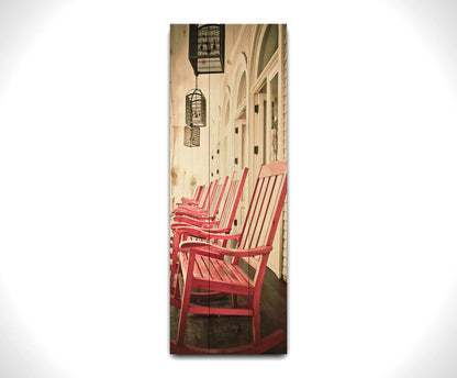 A photo looking down a row of rocking chairs on a porch in O'ahu, Hawaiʻi. Printed on a wood pallet.