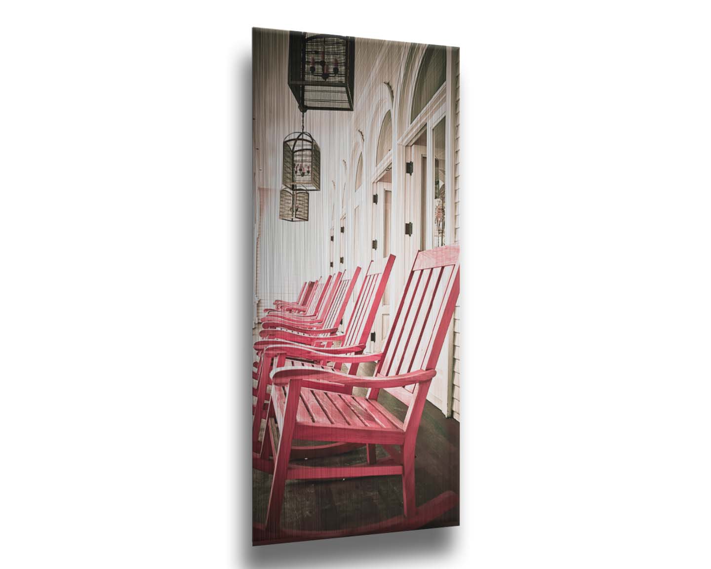 A photo looking down a row of rocking chairs on a porch in O'ahu, Hawaiʻi. Printed on metal.