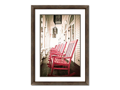 A photo looking down a row of rocking chairs on a porch in O'ahu, Hawaiʻi. Printed on paper, matted, and framed.