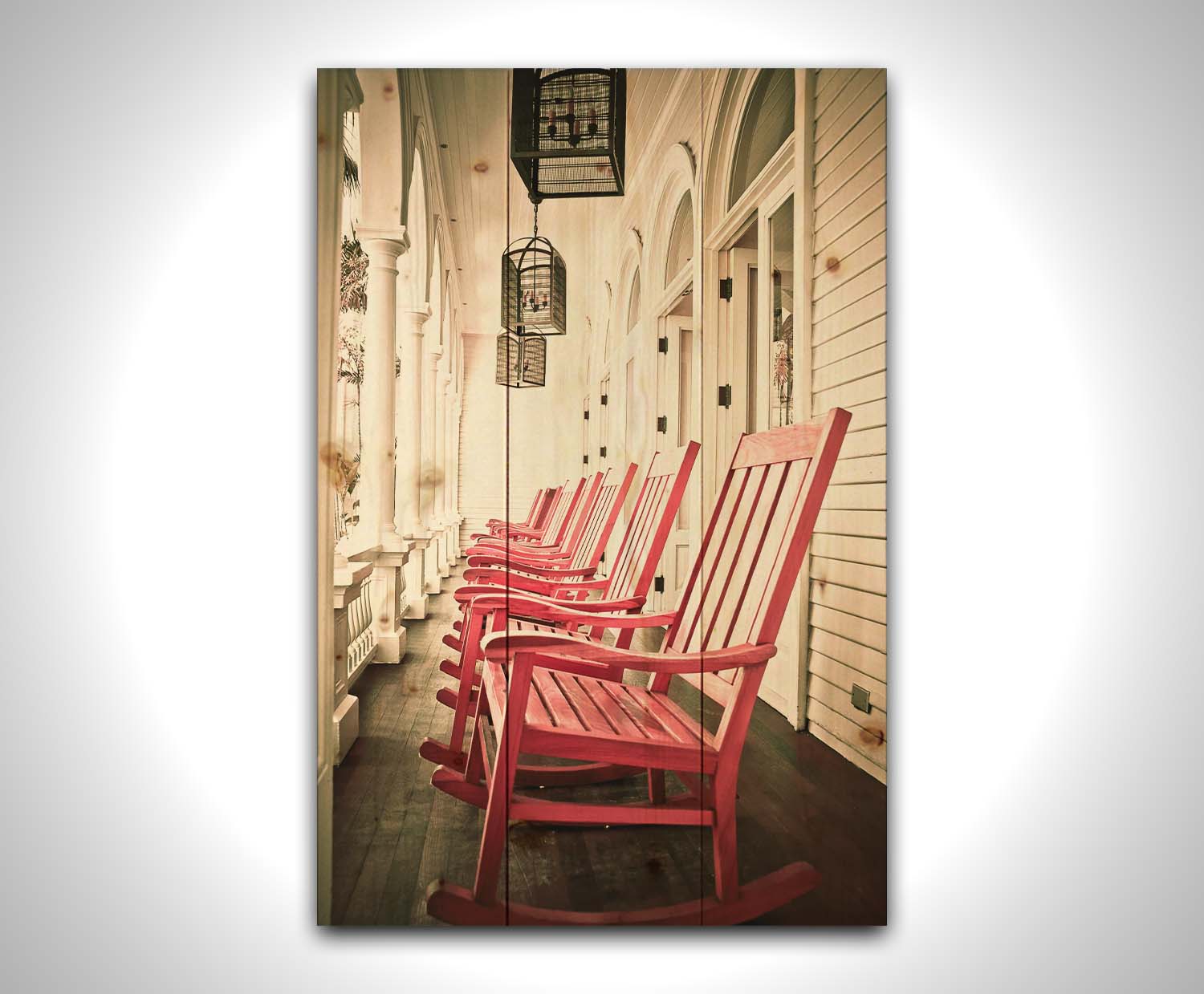 A photo looking down a row of rocking chairs on a porch in O'ahu, Hawaiʻi. Printed on a wood pallet.