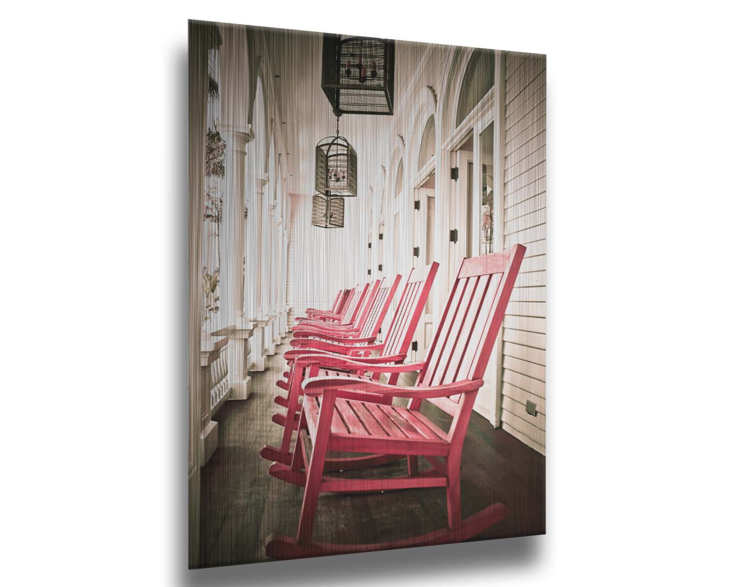 A photo looking down a row of rocking chairs on a porch in O'ahu, Hawaiʻi. Printed on metal.