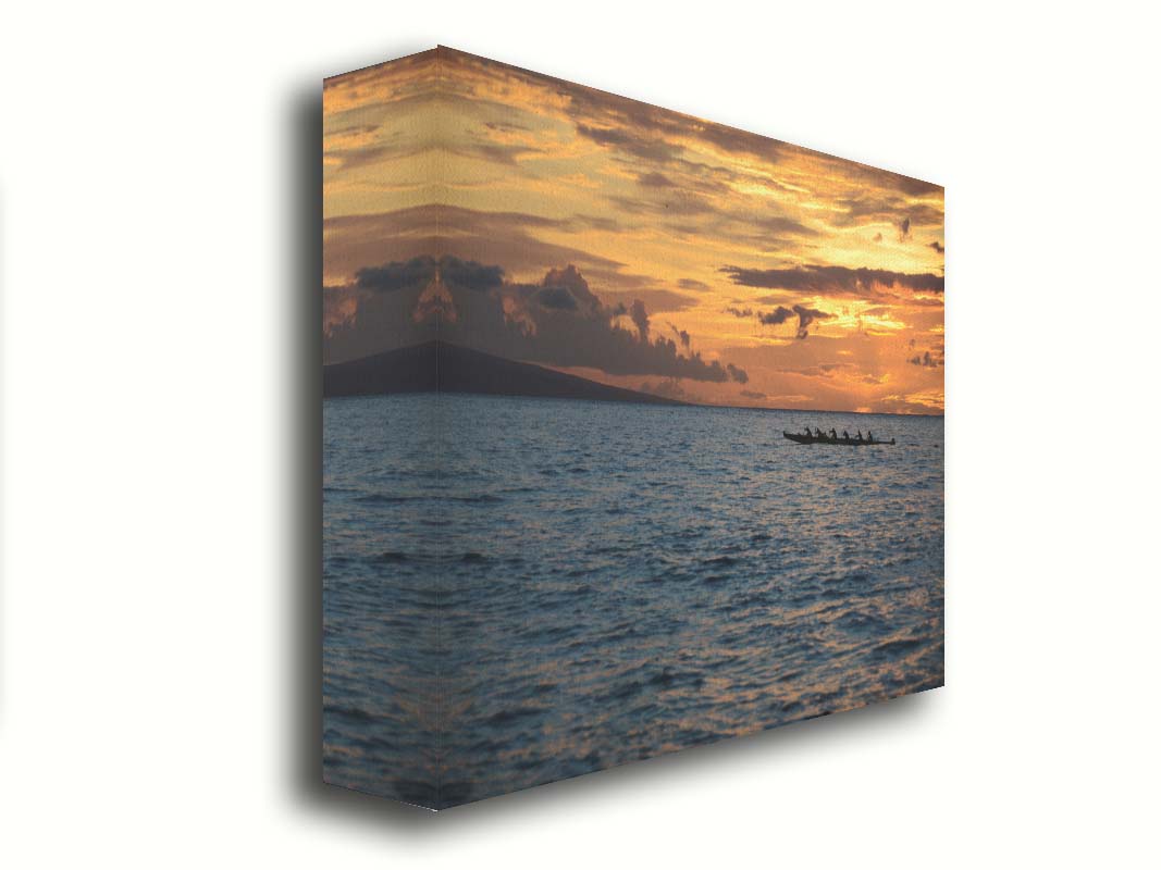 A photo of an outrigger canoe silhouetted on the sea by an orange sunset off the coat of Hawaiʻi. Printed on canvas.