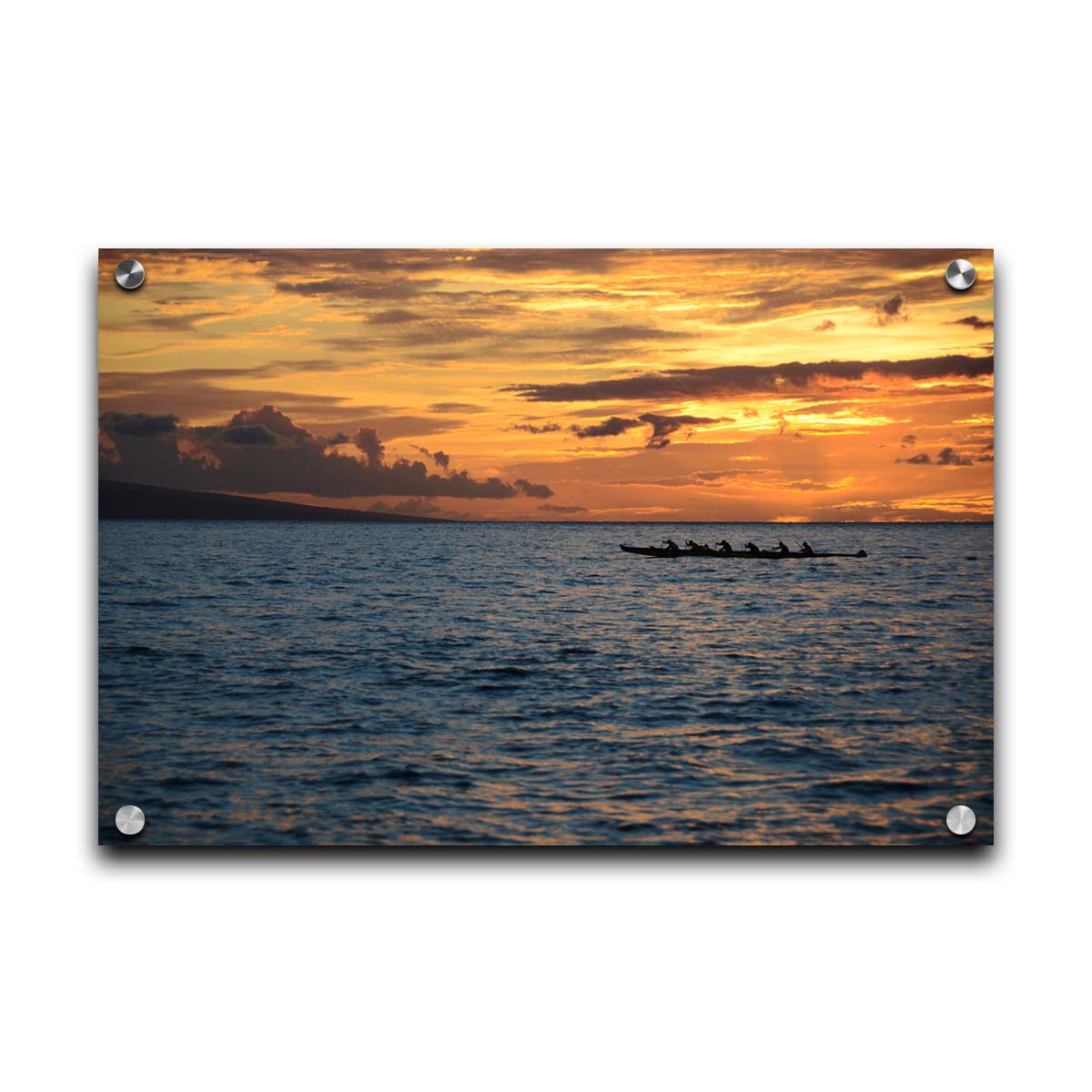 A photo of an outrigger canoe silhouetted on the sea by an orange sunset off the coat of Hawaiʻi. Printed on acrylic.