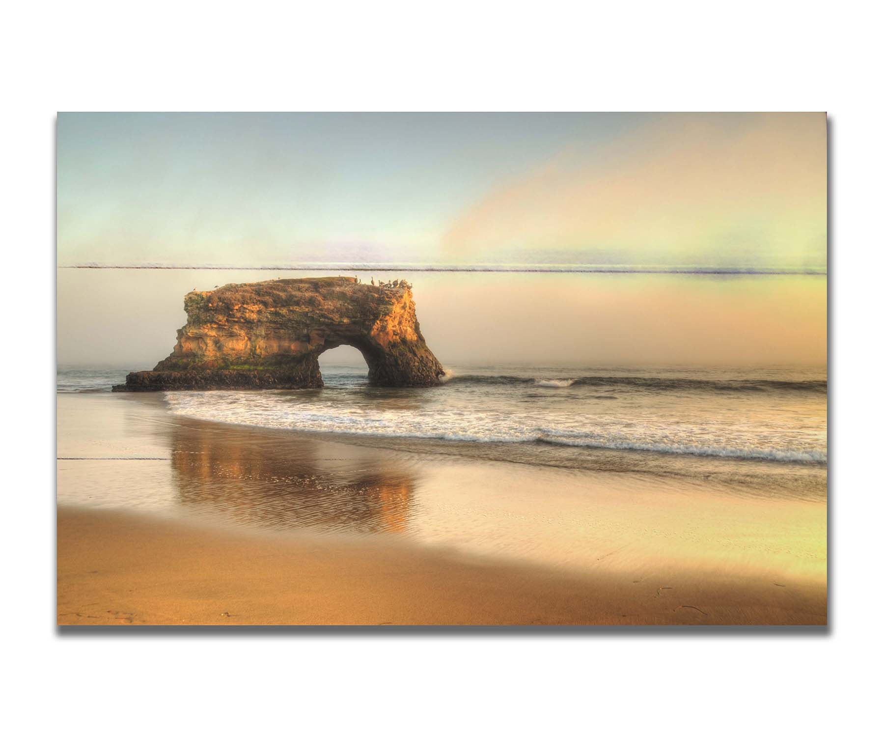 A photo of a "natural bridge" rock formation in Santa Cruz, California. A group of pelicans sit on top of the structure above the sea. Printed on a box board.