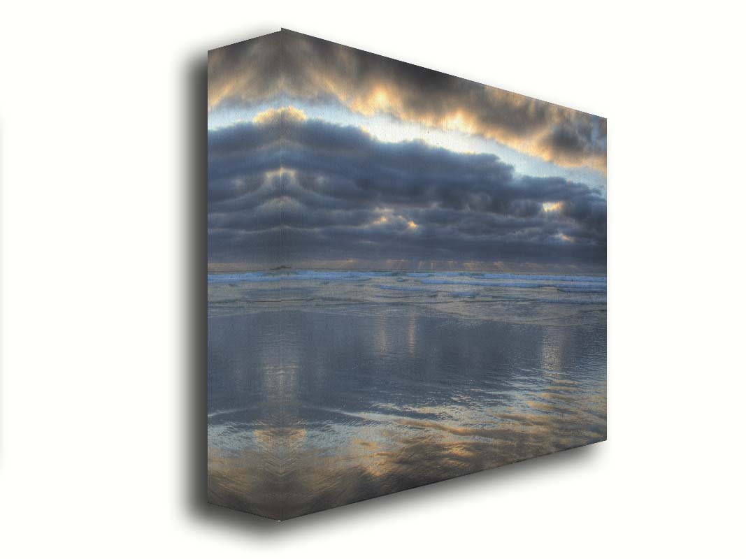 A photo of the sea at La Jolla as viewed near the Ellen Browning Scripps Memorial Research Pier. Rays of light can be seen shining down onto the sea from the cloudy sky. Printed on canvas.