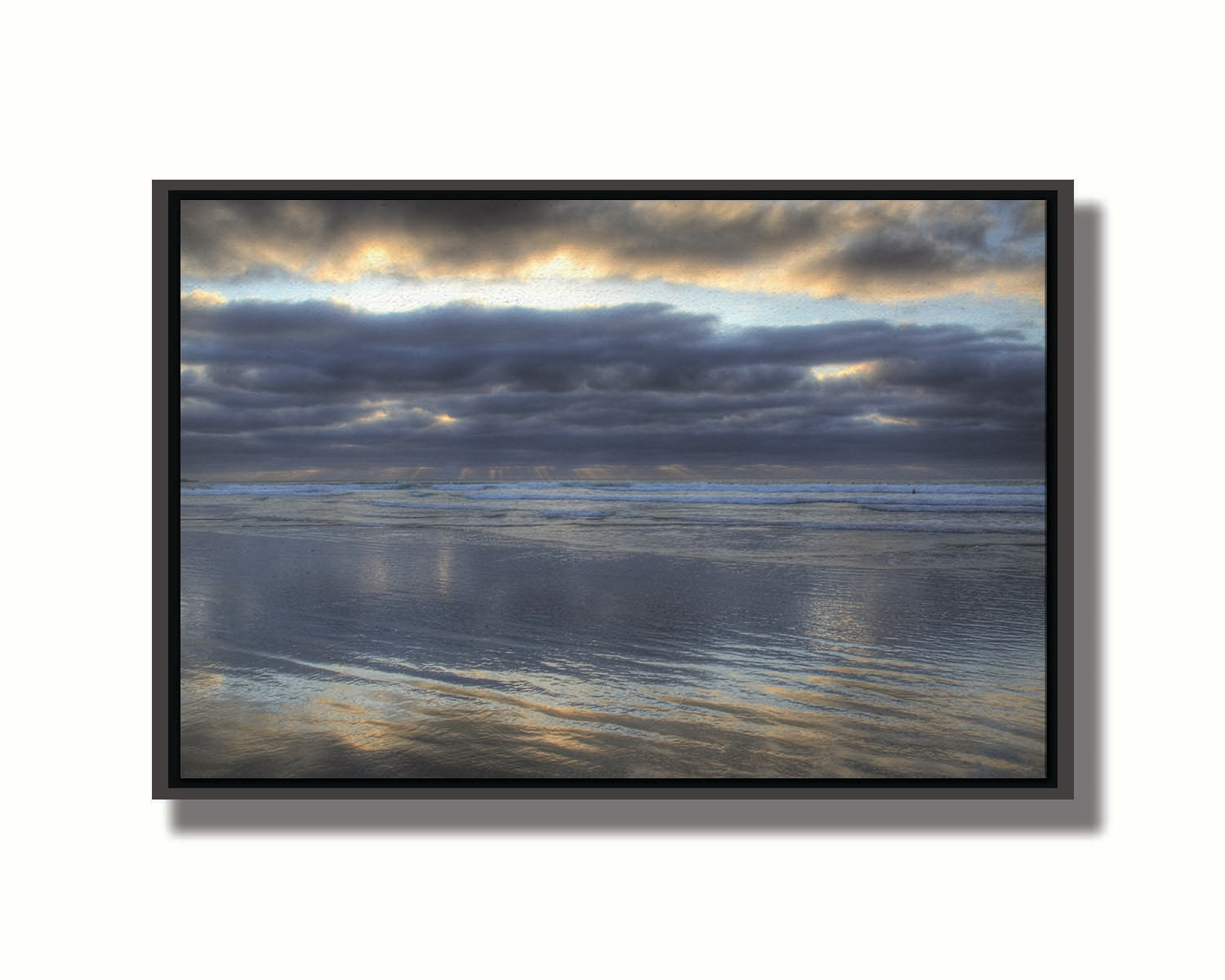 A photo of the sea at La Jolla as viewed near the Ellen Browning Scripps Memorial Research Pier. Rays of light can be seen shining down onto the sea from the cloudy sky. Printed on canvas in a float frame.