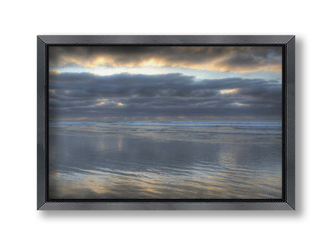 A photo of the sea at La Jolla as viewed near the Ellen Browning Scripps Memorial Research Pier. Rays of light can be seen shining down onto the sea from the cloudy sky. Printed on canvas and framed.