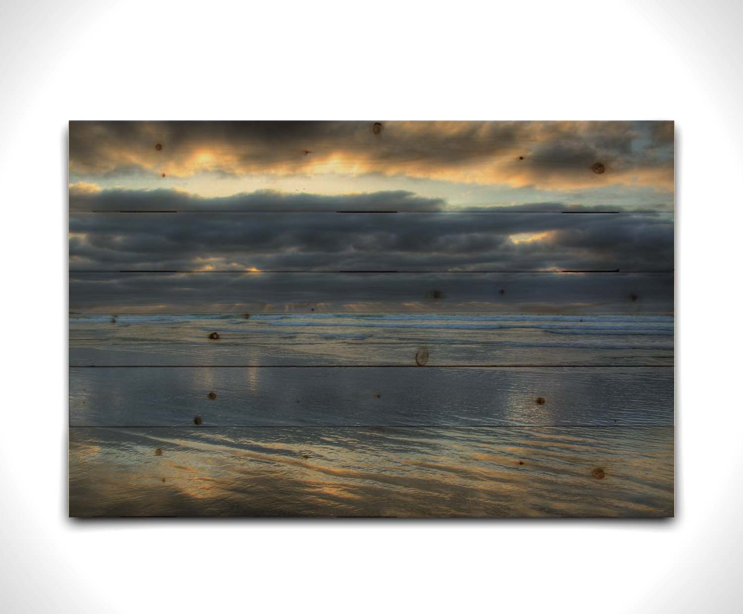 A photo of the sea at La Jolla as viewed near the Ellen Browning Scripps Memorial Research Pier. Rays of light can be seen shining down onto the sea from the cloudy sky. Printed on a wood pallet.