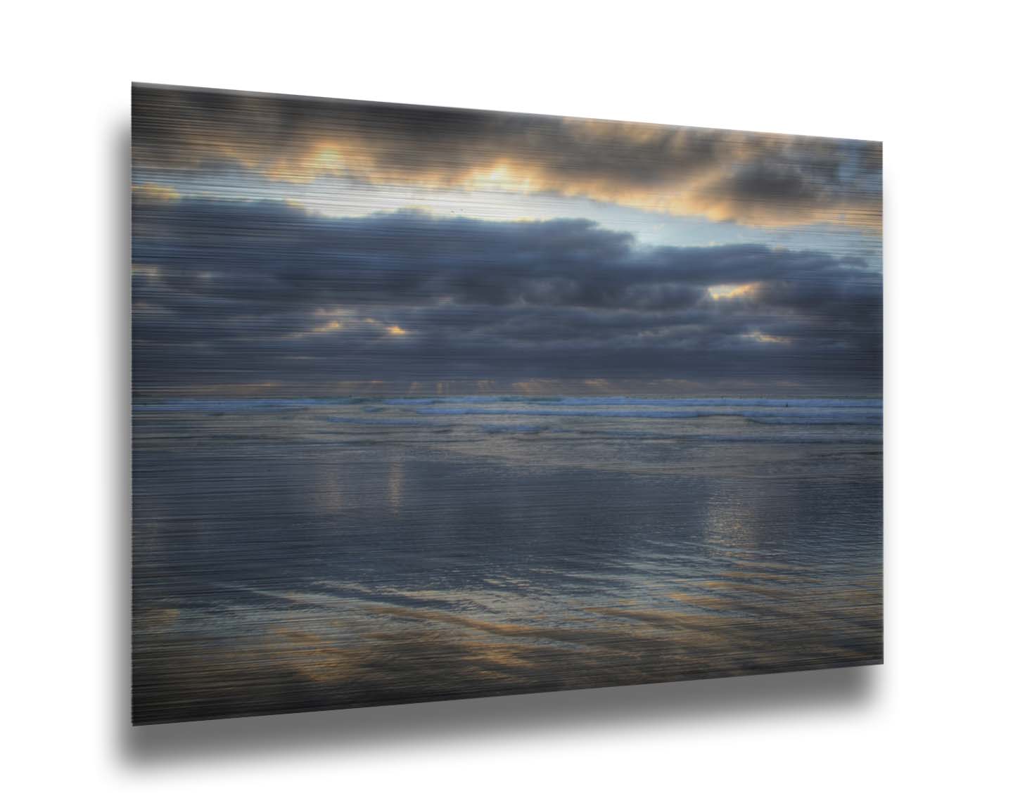 A photo of the sea at La Jolla as viewed near the Ellen Browning Scripps Memorial Research Pier. Rays of light can be seen shining down onto the sea from the cloudy sky. Printed on metal.