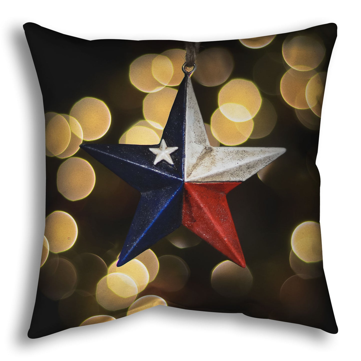 A throw pillow printed with the image of a star-shaped texas flag christmas ornament.