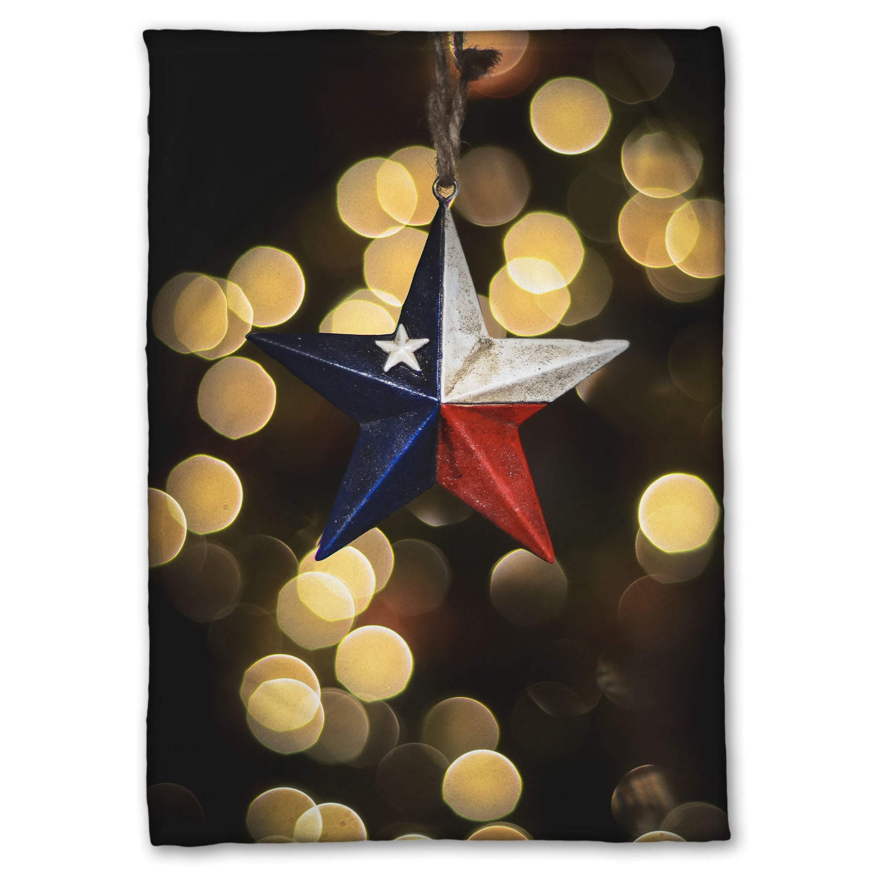 A coral fleece blanket printed with the image of a star-shaped texas flag christmas ornament.