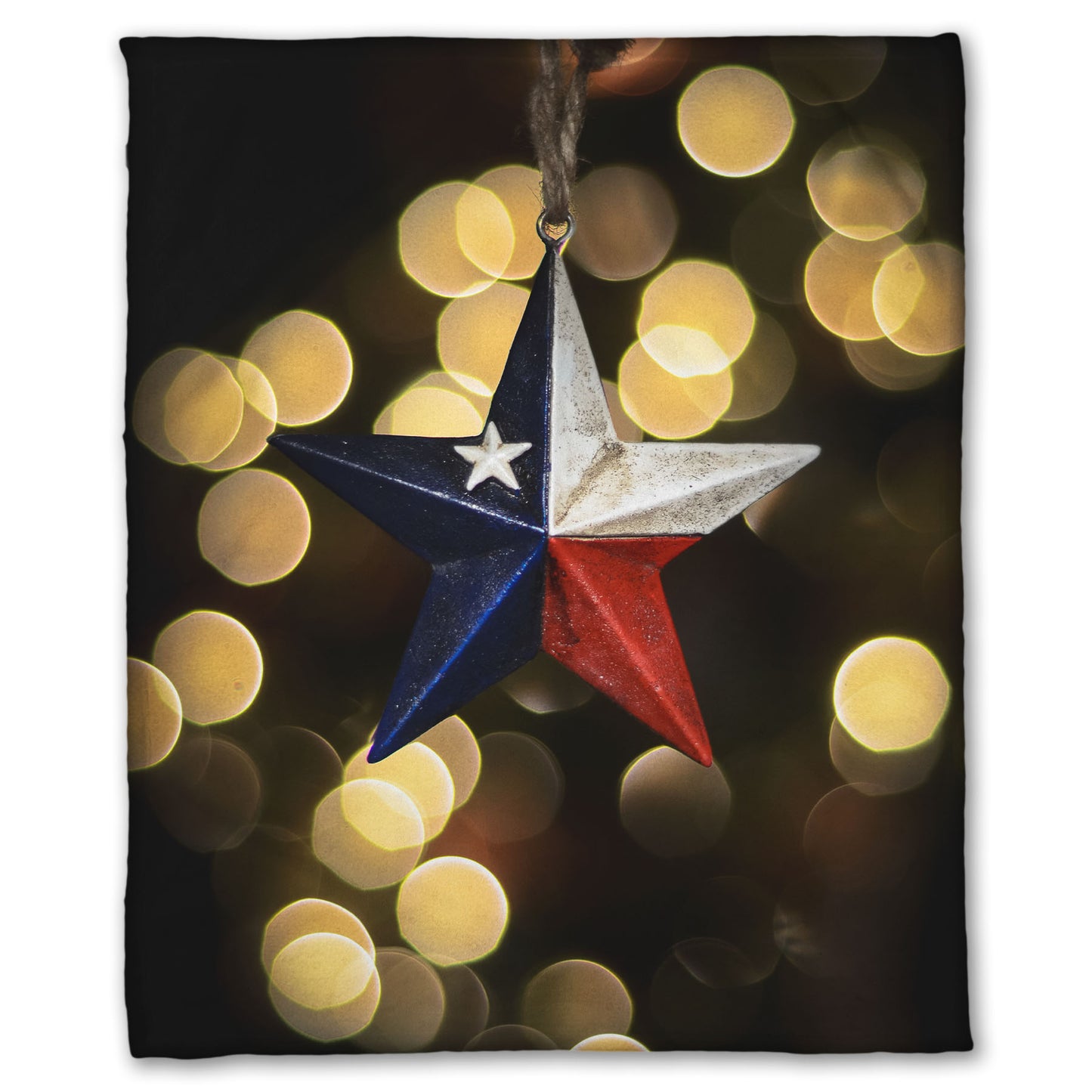 A coral fleece blanket printed with the image of a star-shaped texas flag christmas ornament.