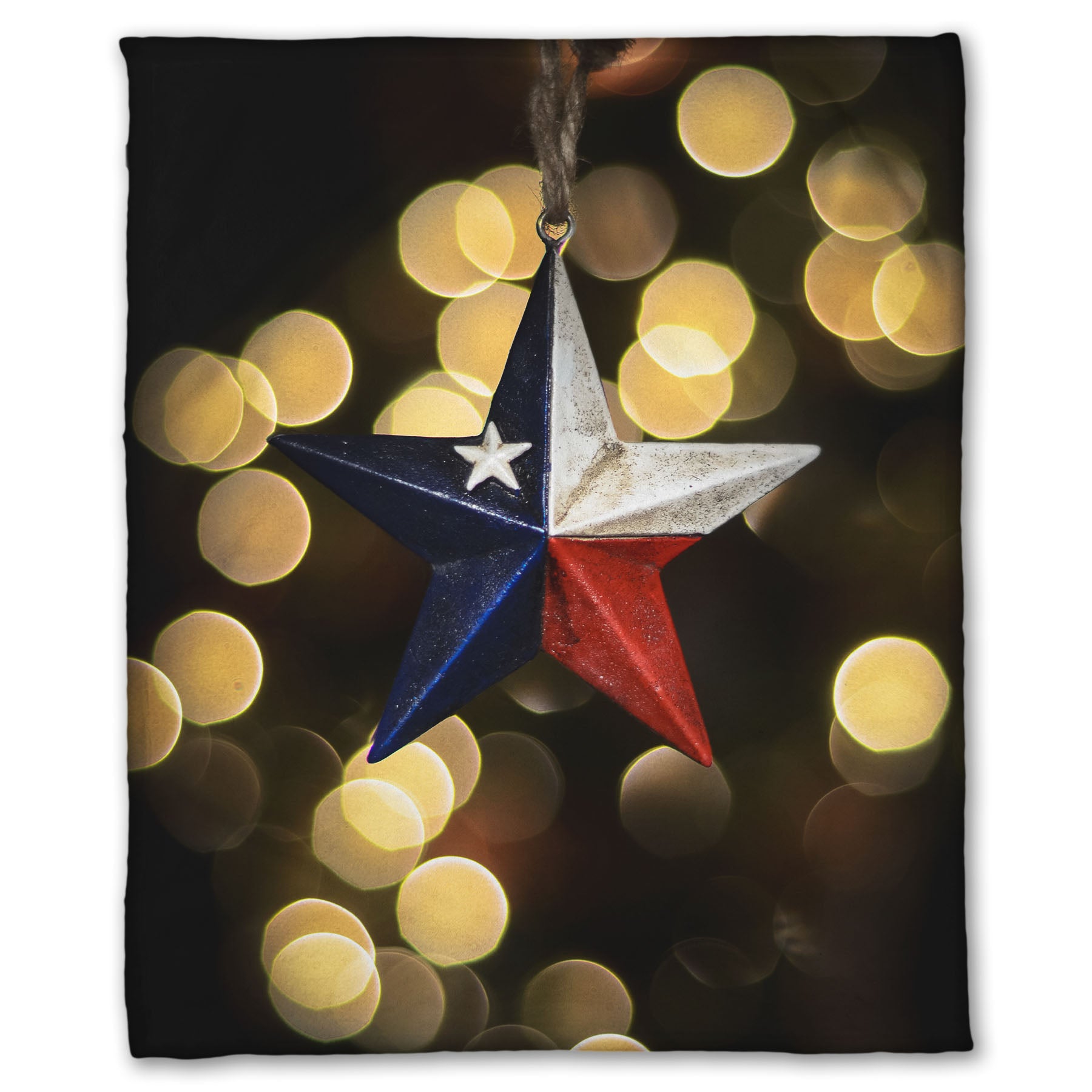A coral fleece blanket printed with the image of a star-shaped texas flag christmas ornament.