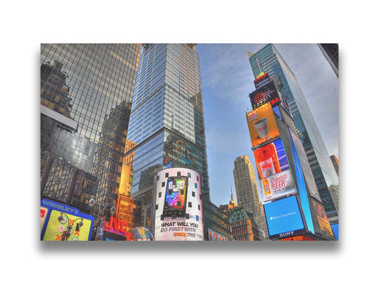 A photo looking up at the buildings and advertisements of Times Square in New York. Printed on canvas.