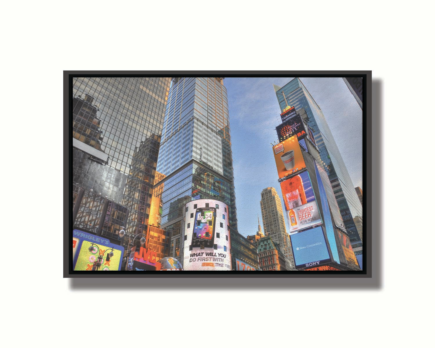 A photo looking up at the buildings and advertisements of Times Square in New York. Printed on canvas in a float frame.