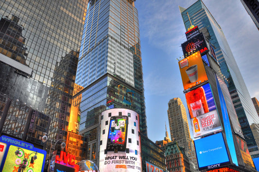 A photo looking up at the buildings and advertisements of Times Square in New York.