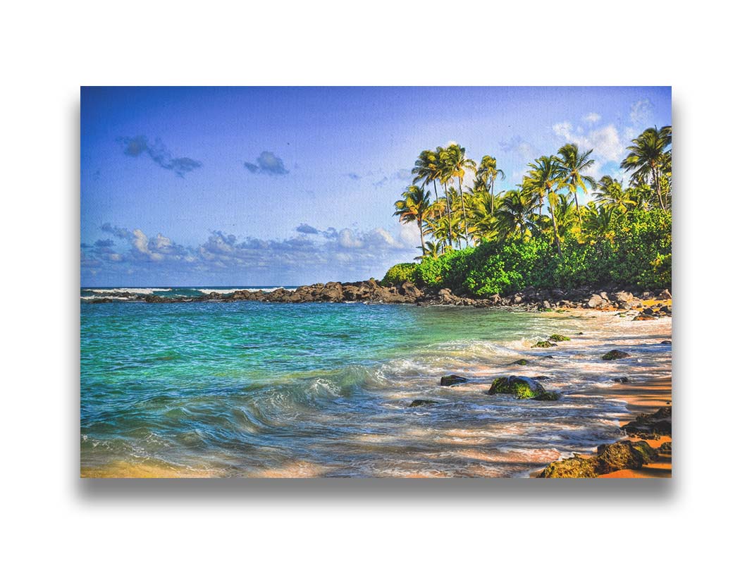 A photo of Laniākea beach. The water is a vibrant blue-green, and the stony beach circles around in the background where lush foliage and palm trees grow under a bright blue sky. Printed on canvas.