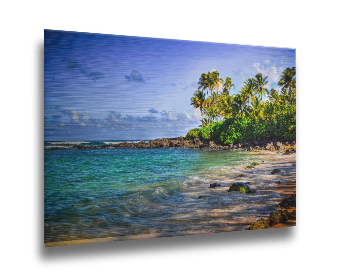 A photo of Laniākea beach. The water is a vibrant blue-green, and the stony beach circles around in the background where lush foliage and palm trees grow under a bright blue sky. Printed on metal.