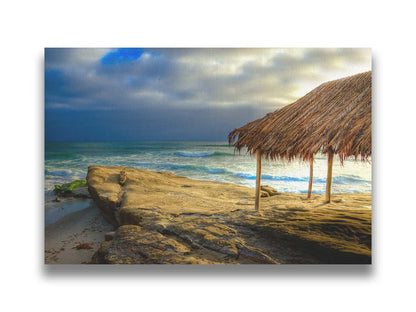 A photo of the palapa at Windansea beach, sitting on a rock in  the fading sunshine. Printed on canvas.