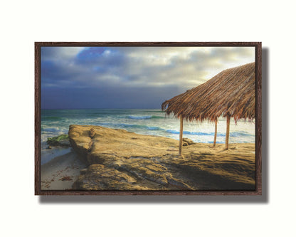 A photo of the palapa at Windansea beach, sitting on a rock in  the fading sunshine. Printed on canvas in a float frame.