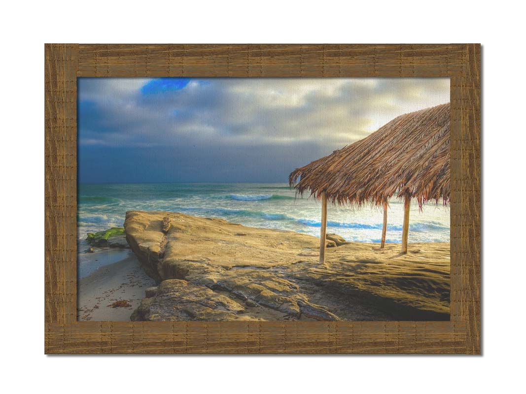 A photo of the palapa at Windansea beach, sitting on a rock in  the fading sunshine. Printed on canvas and framed.