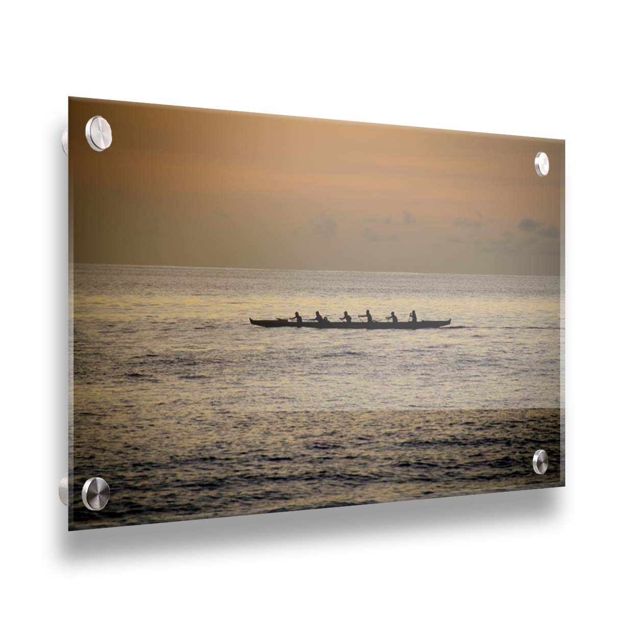 A photo of an outrigger canoe at sea, silhouetted against an orange sky. Printed on acrylic.