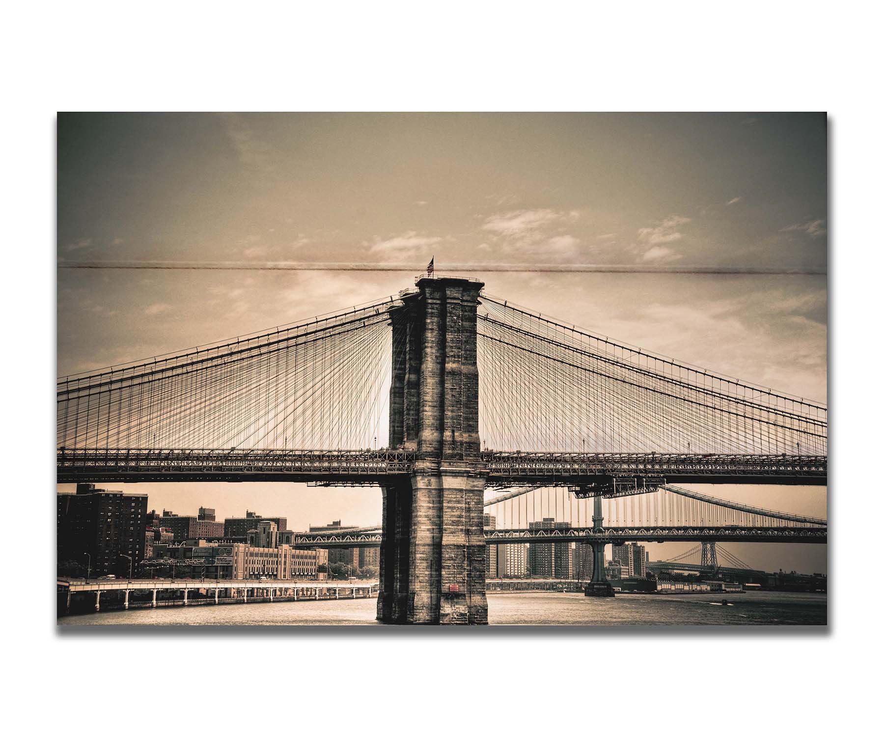 A sepia photo of the brooklyn bridge from the side, accented with a dark vignette. Printed on a box board.