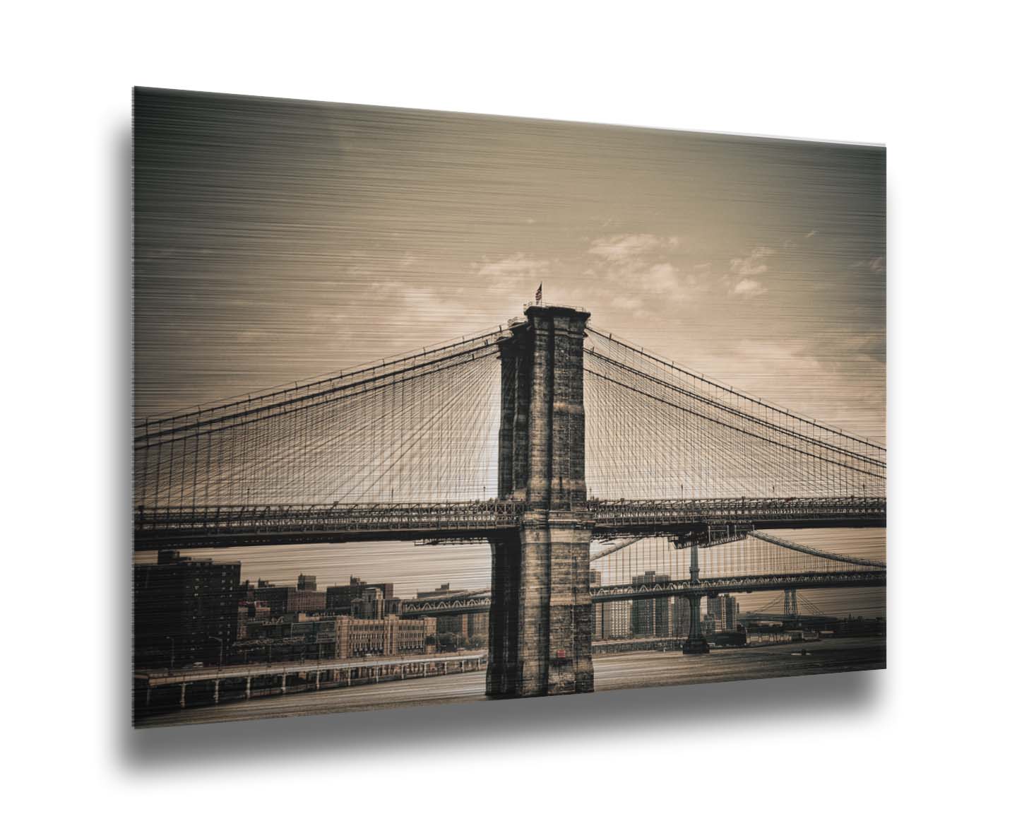 A sepia photo of the brooklyn bridge from the side, accented with a dark vignette. Printed on metal.