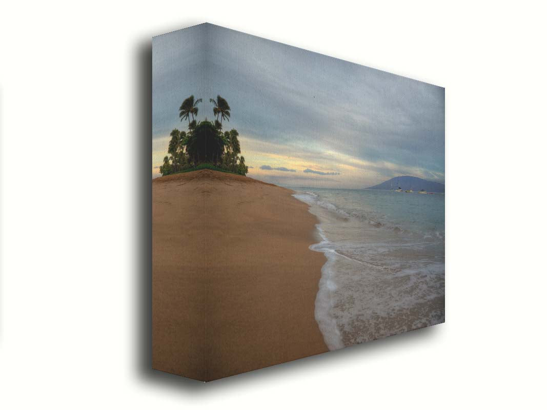 A photo of a cloudy sunrise on the Kaʻanapali shore, looking out to sea. Sailboats can be seen out on the water. Printed on canvas.