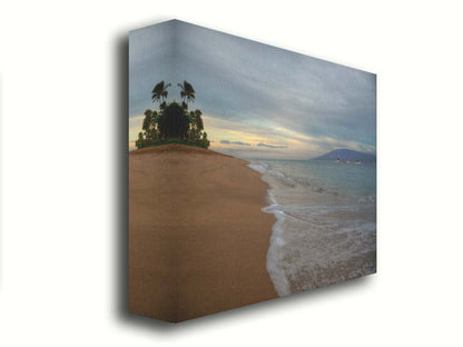 A photo of a cloudy sunrise on the Kaʻanapali shore, looking out to sea. Sailboats can be seen out on the water. Printed on canvas.