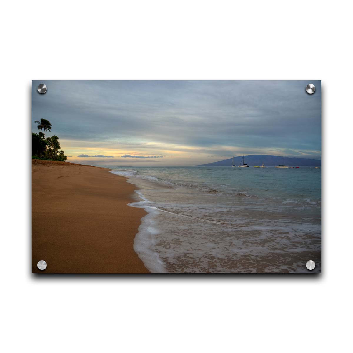 A photo of a cloudy sunrise on the Kaʻanapali shore, looking out to sea. Sailboats can be seen out on the water. Printed on acrylic.