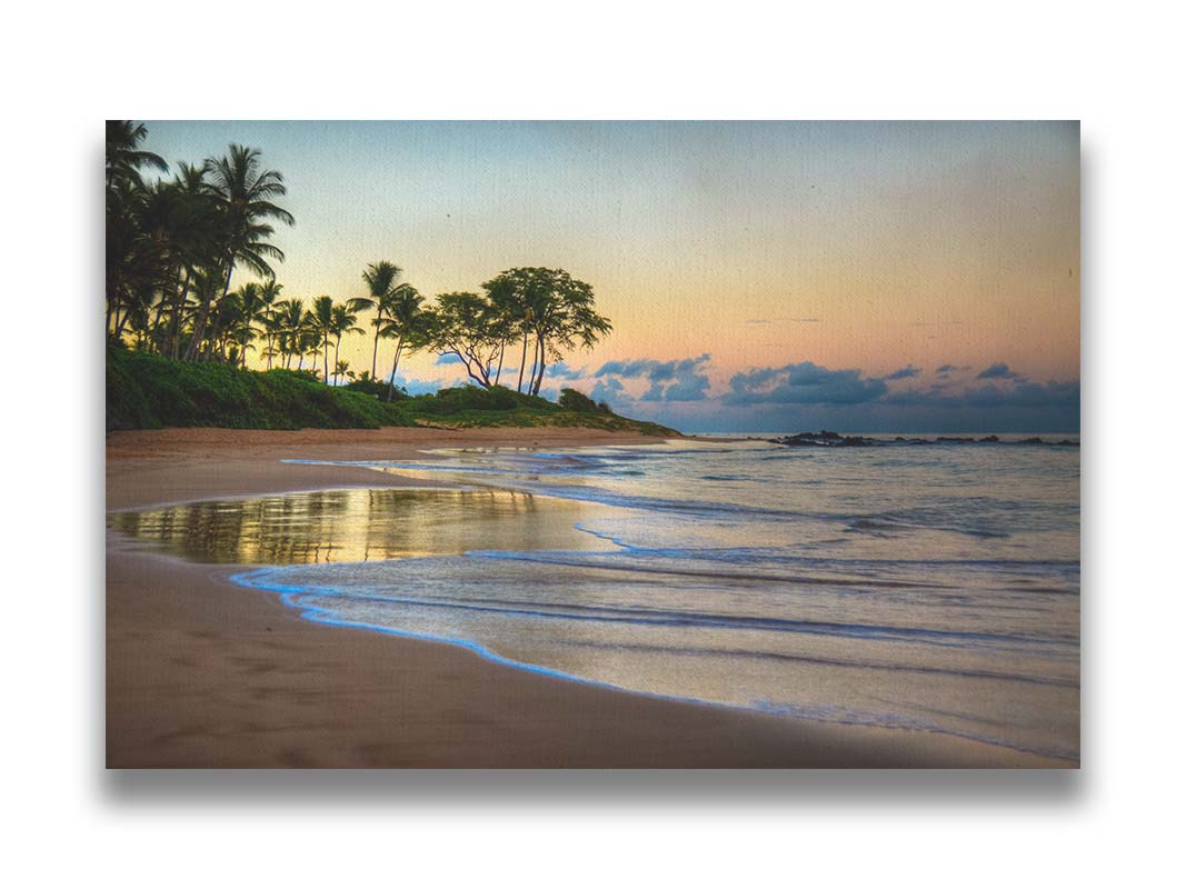 A photo of Keawakapu Beach at sunrise, with palms and mountains in the distance. Printed on canvas.