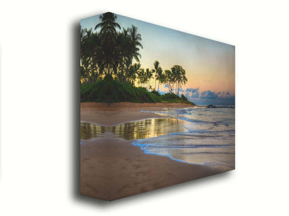 A photo of Keawakapu Beach at sunrise, with palms and mountains in the distance. Printed on canvas.