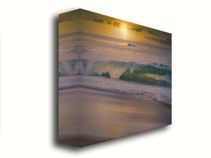 A photo of a calm sea wave rolling onto the beach on Maui at sunset. A boat can be seen on the water in the distance. Printed on canvas.