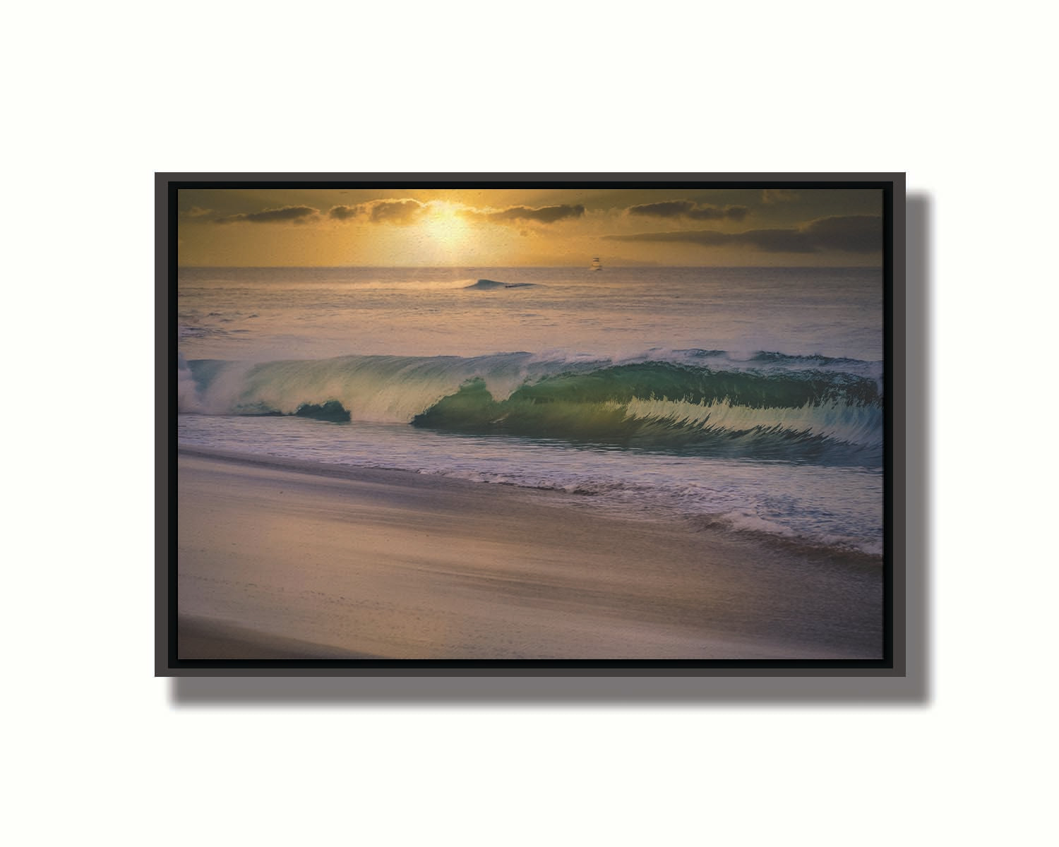 A photo of a calm sea wave rolling onto the beach on Maui at sunset. A boat can be seen on the water in the distance. Printed on canvas in a float frame.