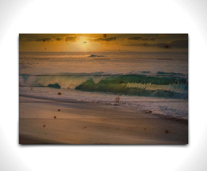 A photo of a calm sea wave rolling onto the beach on Maui at sunset. A boat can be seen on the water in the distance. Printed on a wood pallet.